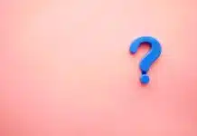 a blue question mark on a pink background