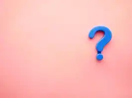 a blue question mark on a pink background